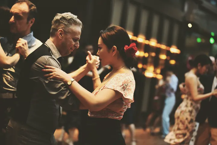 Dancers sharing a close embrace at a social dance event